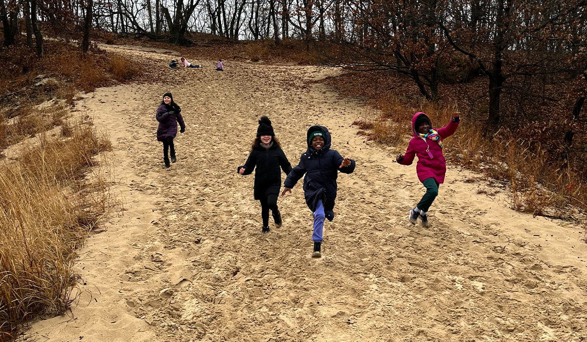 Kids running down the dunes